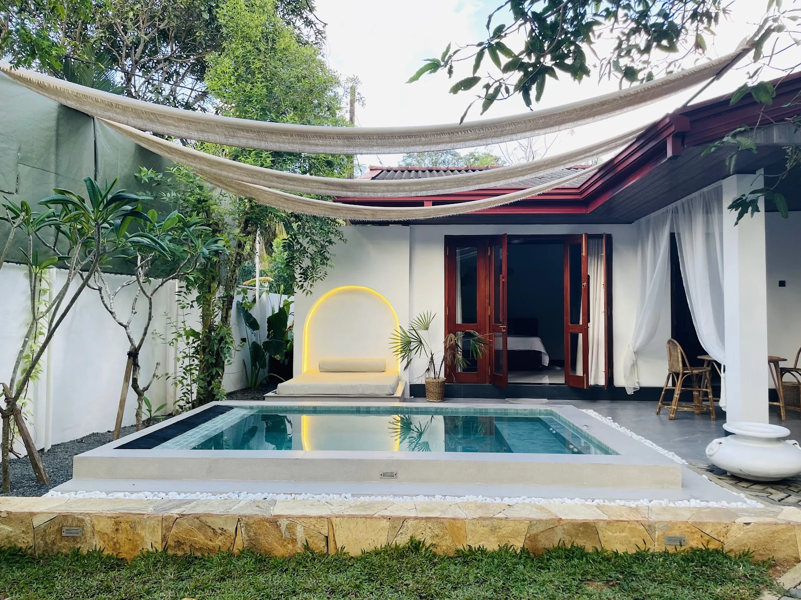 Villa Araliya sun-drenched daytime plunge pool and colonial white facade